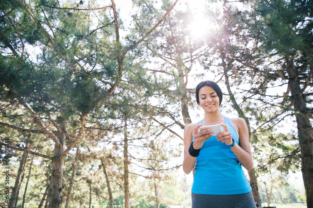 Sporty woman using smartphone