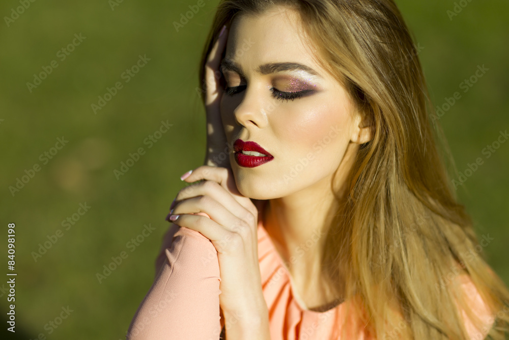 Portrait of pretty passionate woman in peach dress Portrait of pretty passionate woman in peach dress