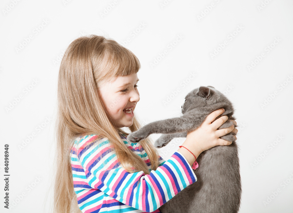 Happy little girl holding a cat Happy little girl holding a cat