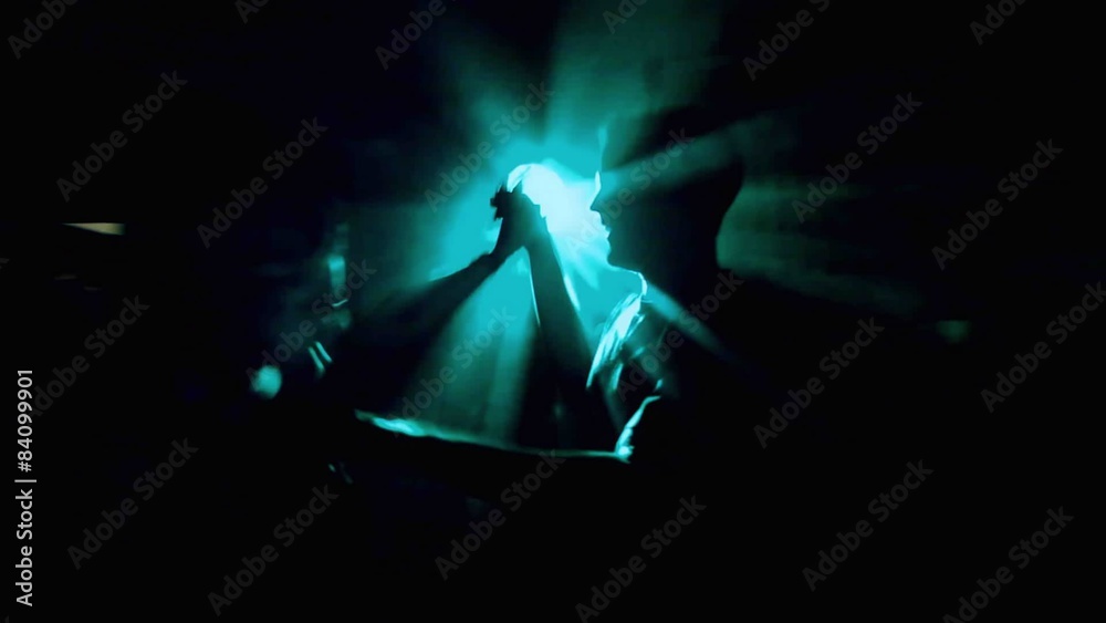 A couple dances in laser light at a house party