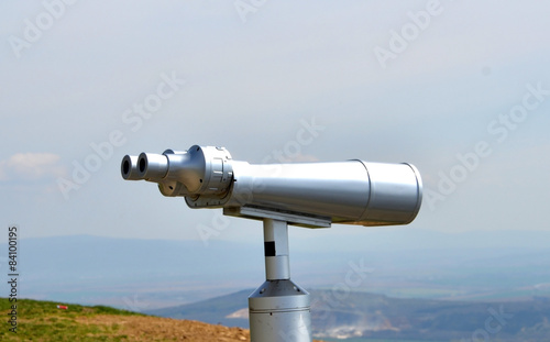 big silver metal binoculars to see the landscape