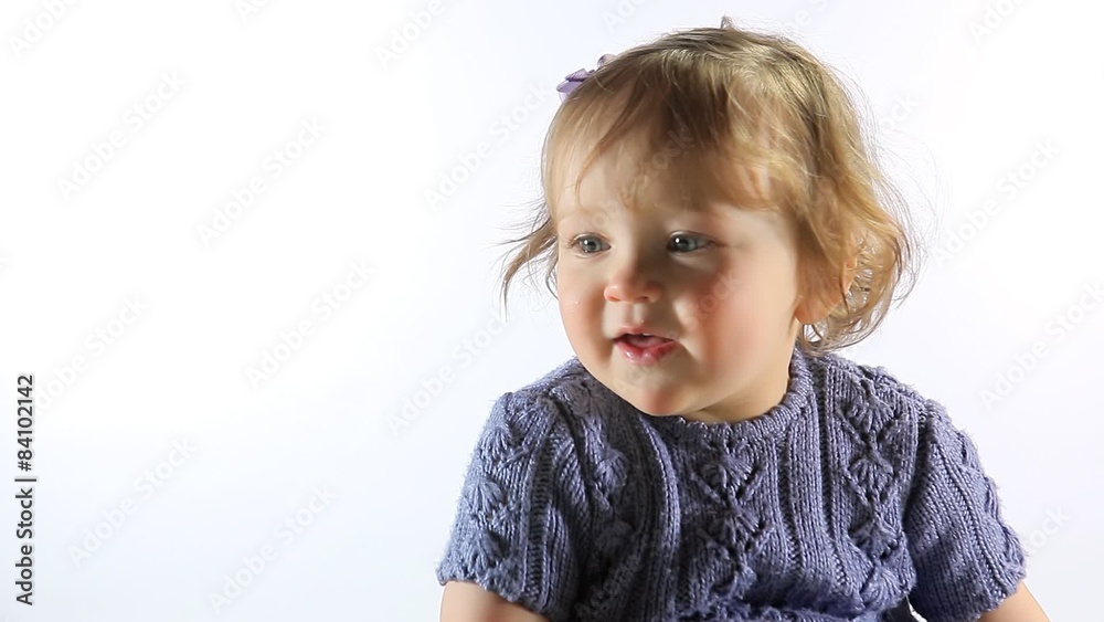 Cute little girl looks around then smiles Cute little girl looks around then smiles
