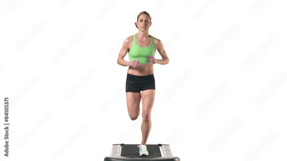 Wide shot of a female running in place on a treadmill Wide shot of a female running in place on a treadmill