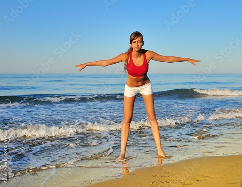 Healthy woman doing exercising on the beach, girl doing sport ou © nmelnychuk