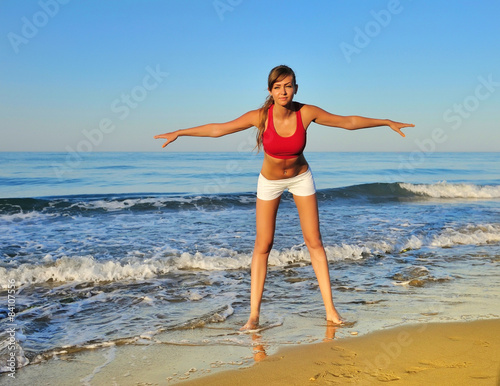 Healthy woman doing exercising on the beach, girl doing sport ou