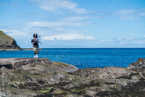Traditional bagpiper in the scottish highlands near Pennan