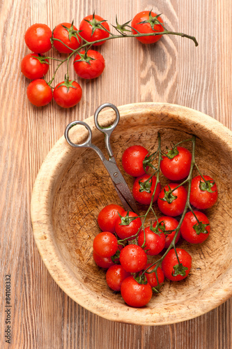 Cherry tomatoes in rustic bowl. top view