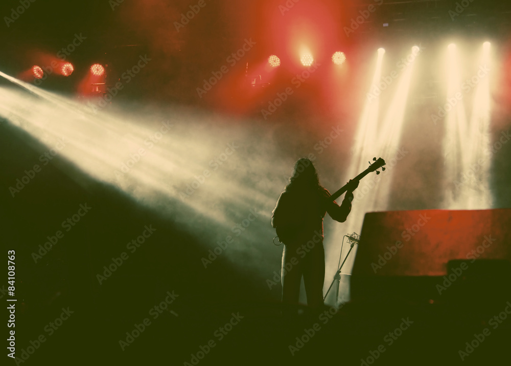 Guitarist silhouette in smoke during concert - retro style photo