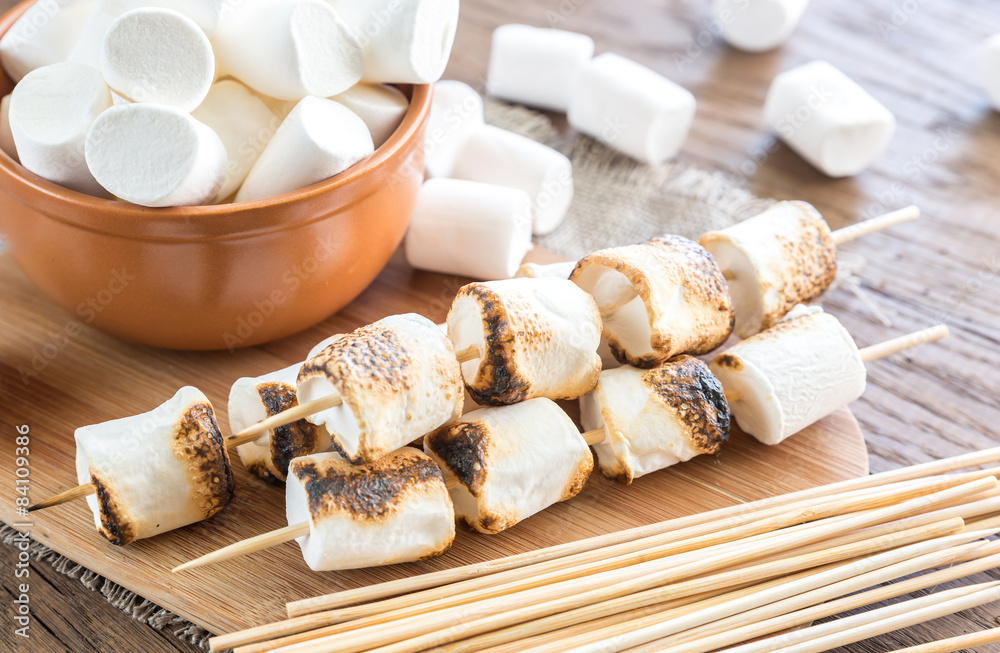 Marshmallow skewers on the wooden board Marshmallow skewers on the wooden board