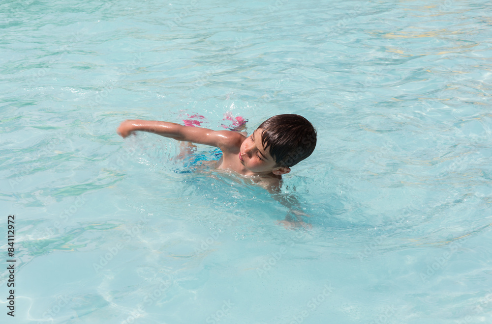 European boy swimming in the pool
