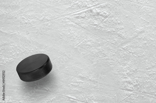 Hockey puck on ice photo