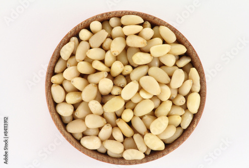 Pine nuts in a round wooden form