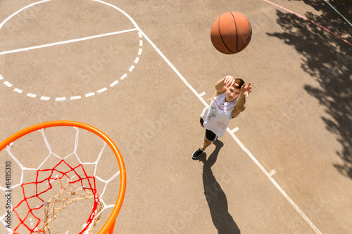 Above View of Man Tossing Basketball into Hoop © kolotype