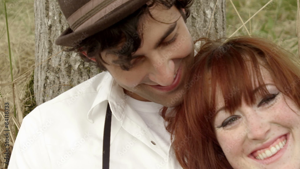 Happy couple lean against a tree and embrace each other. Close up shot. Happy couple lean against a tree and embrace each other. Close up shot.