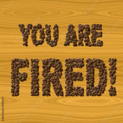Text You Are Fired coffee on wood texture photo