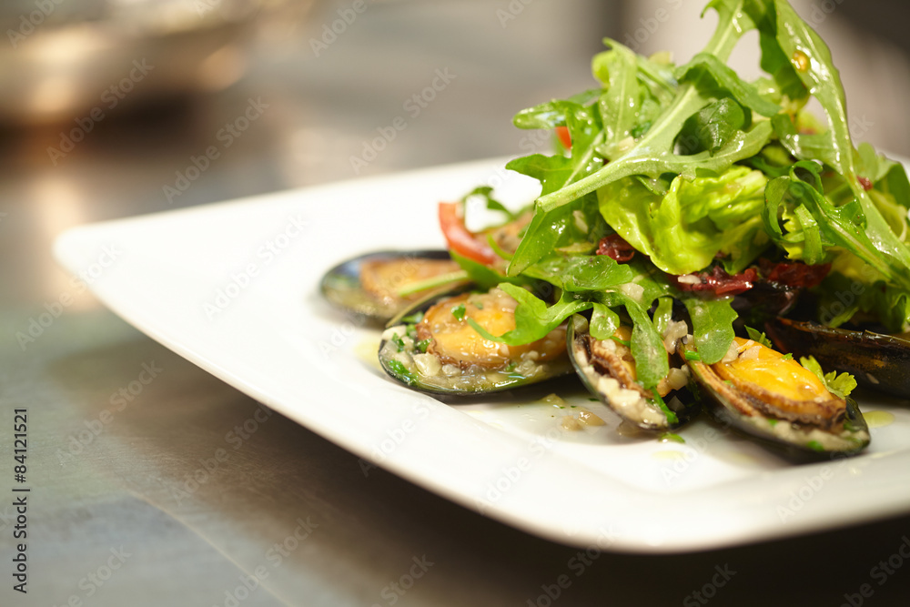salad with mussels on a white plate salad with mussels on a white plate