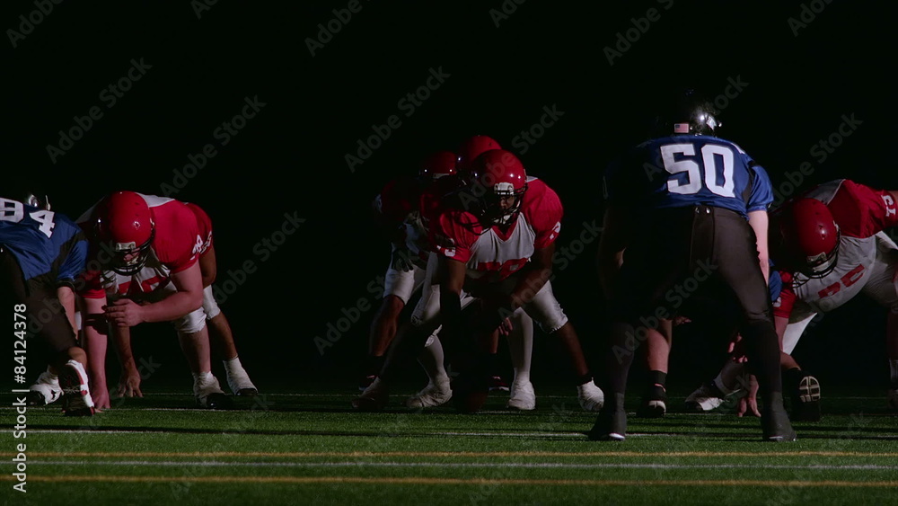Football players stand ready at the line Football players stand ready at the line