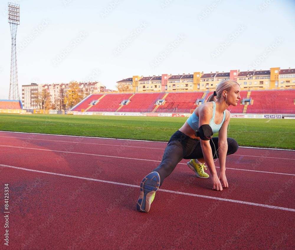 Fototapeta premium sporty woman on athletic race track