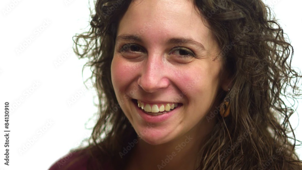 A woman looks into the camera and smiles A woman looks into the camera and smiles