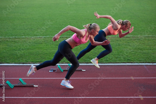 athlete woman group running on athletics race track