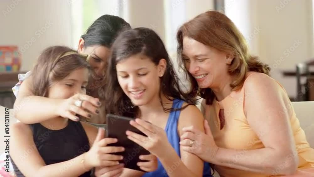 Generations of women using a tablet computer to take pictures Generations of women using a tablet computer to take pictures