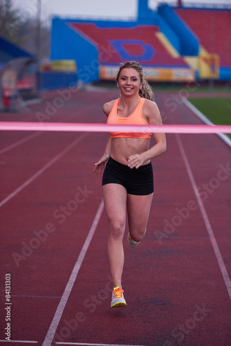 sporty woman on athletic race track