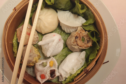 wontons in wooden bowl photo