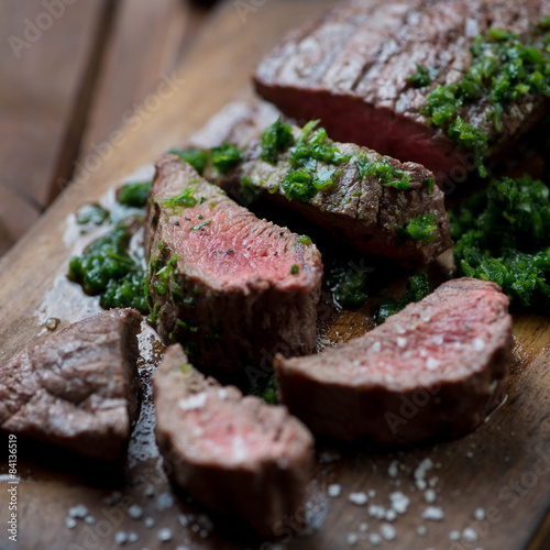 Fotografie Medium rare grilled beef barbecue steak with chimichurri sauce