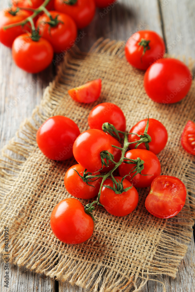 Fresh cherry tomatoes on grey wooden background Fresh cherry tomatoes on grey wooden background