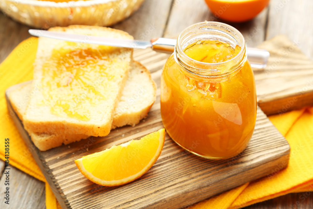 Bread and orange jam on grey wooden background Bread and orange jam on grey wooden background