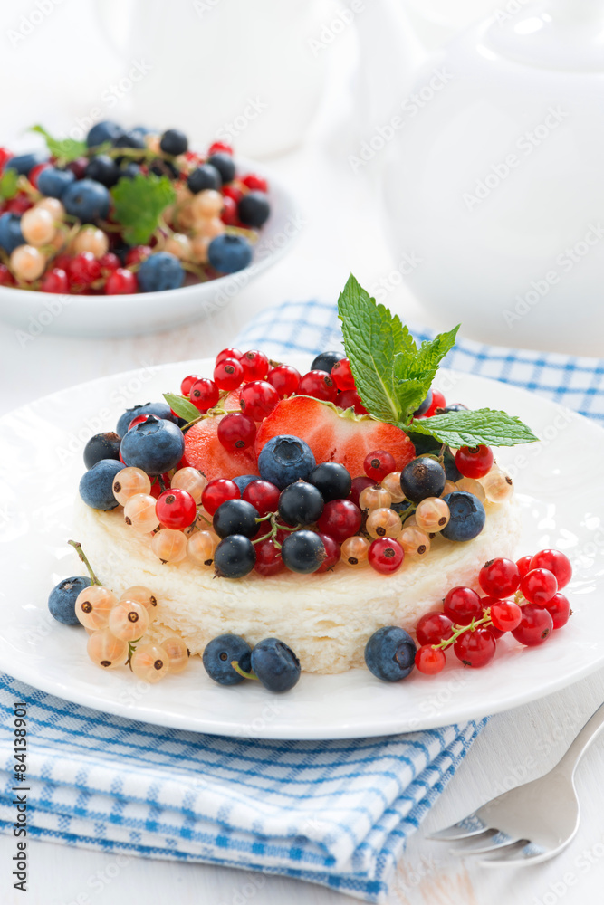 mini cheesecake with fresh berries on a plate, vertical mini cheesecake with fresh berries on a plate, vertical