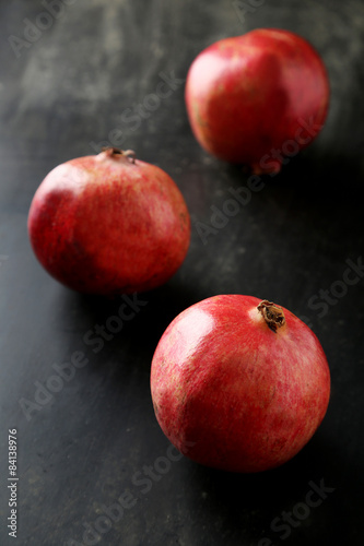 Delicious pomegranate fruit on black background
