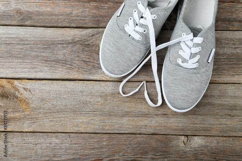 Pair of grey shoes on wooden background