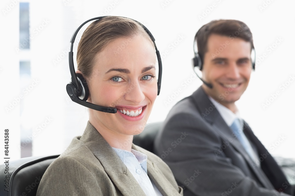Business people with headsets smiling at camera Business people with headsets smiling at camera