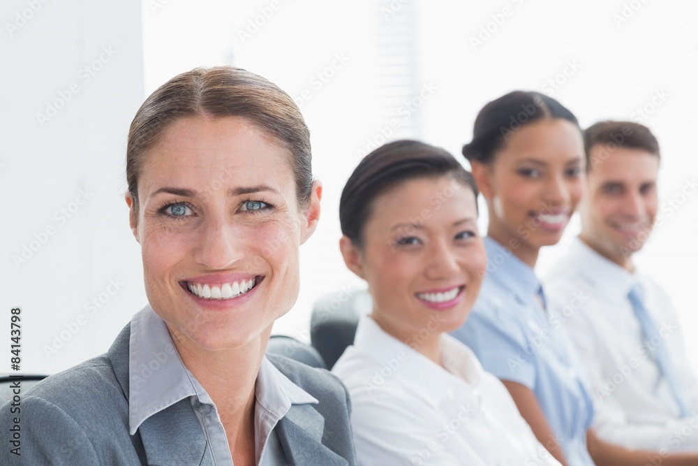 Smiling business people looking at camera Smiling business people looking at camera