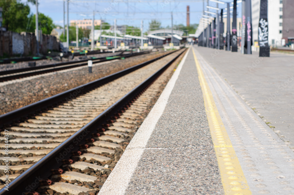 Young man waits train on railway station