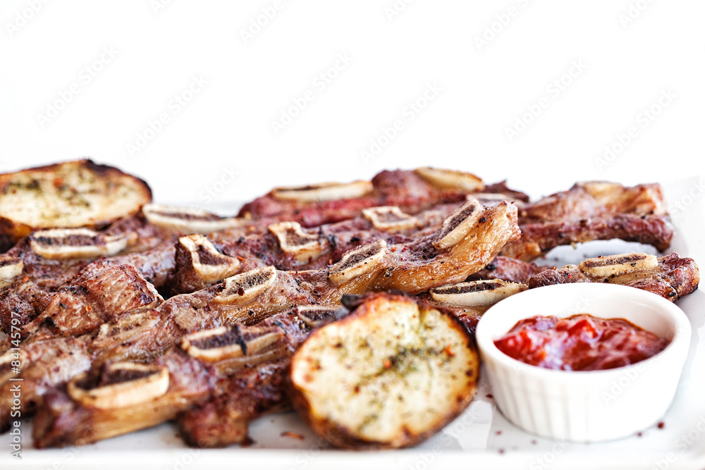Delicious barbecued ribs seasoned with a spicy potato - obrazy, fototapety, plakaty 