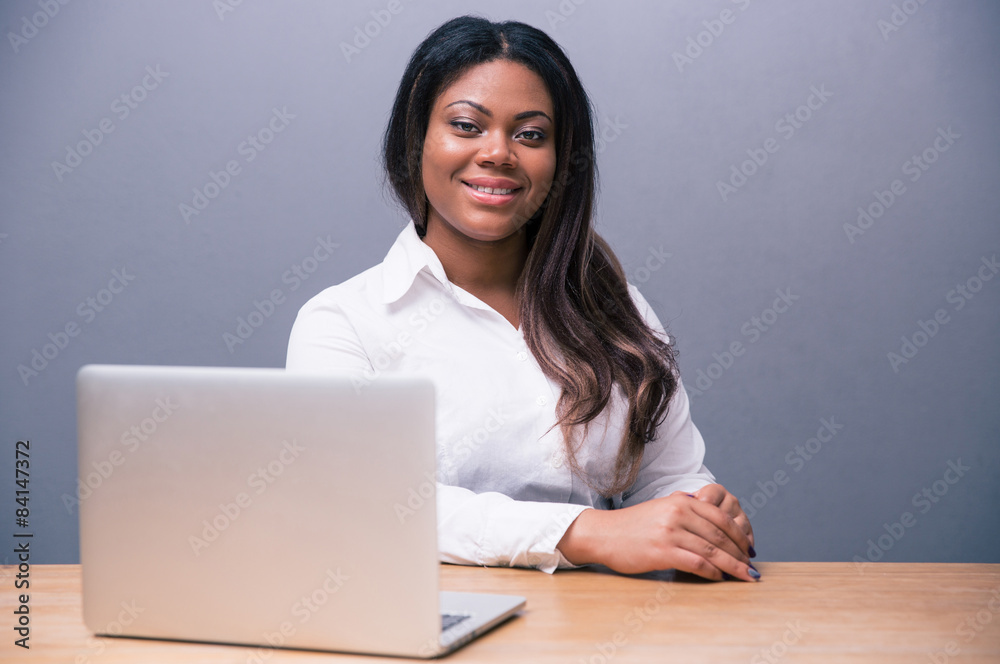 Businesswoman sitting at the table with laptop Businesswoman sitting at the table with laptop