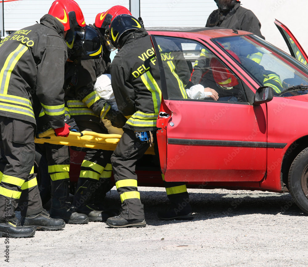 firefighters in action and pull the injured from the car firefighters in action and pull the injured from the car
