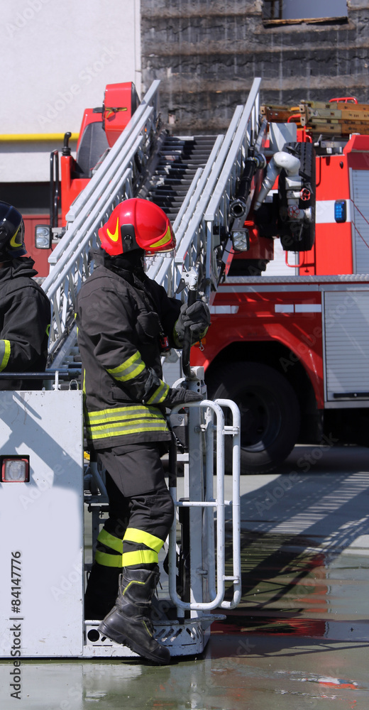 Fototapeta premium firefighter in the cage of fire engine