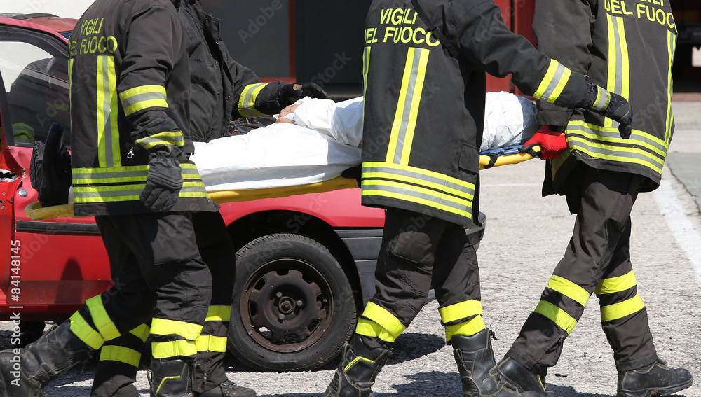 firefighters in action carry a stretcher with injured firefighters in action carry a stretcher with injured