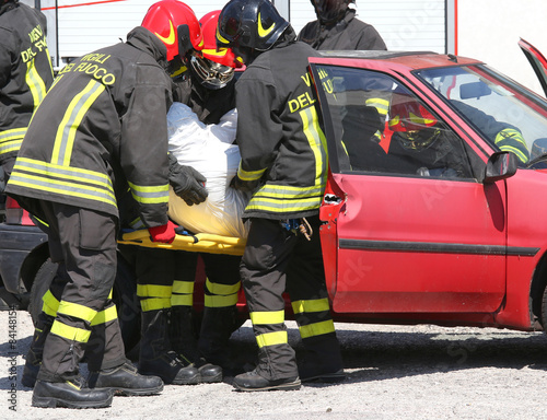 firefighters pull the injured from the car after the road accide