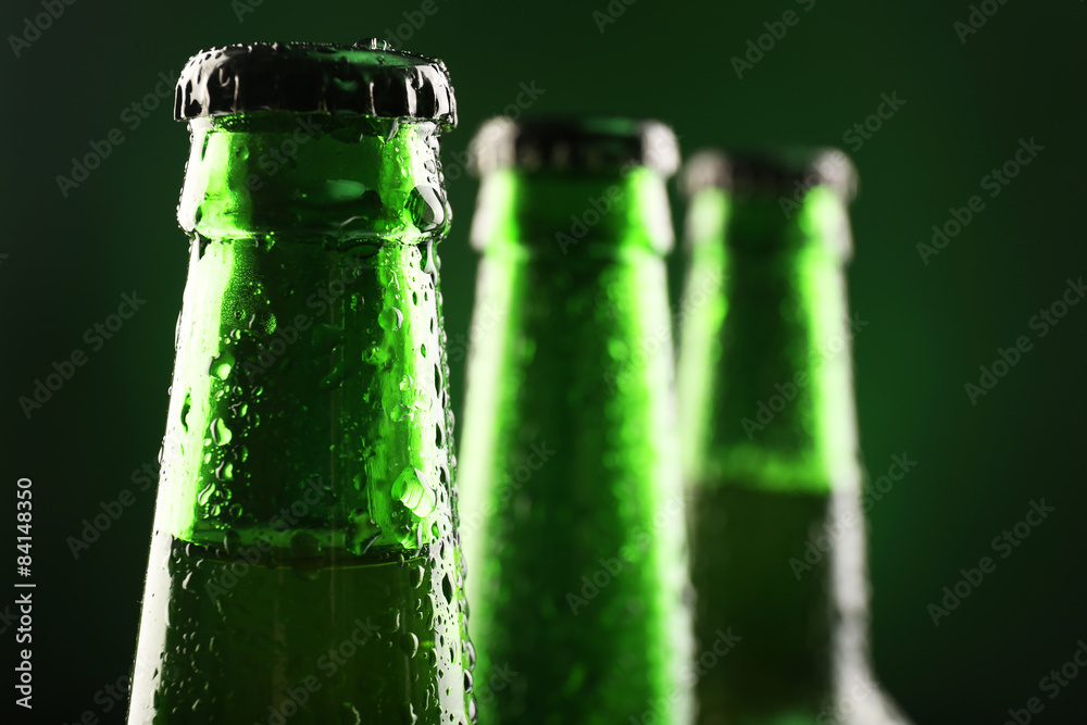 Glass bottles of beer on dark background