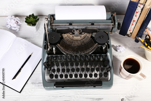 Retro typewriter on wooden background