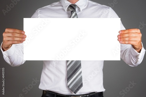 Business man holding a blank board.