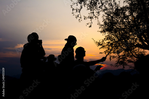 Silhouette of travelers enjoy their moment watching sunset