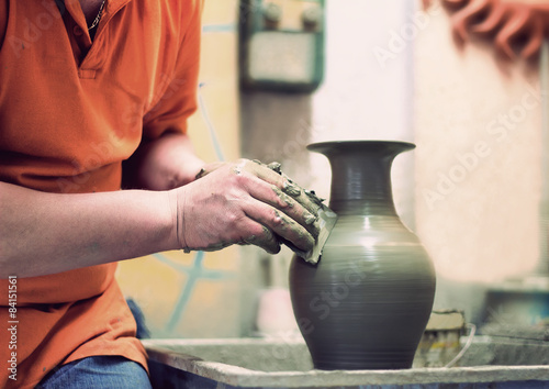 Canvas Print People at work: the production of ceramic vases on a Potter's wh