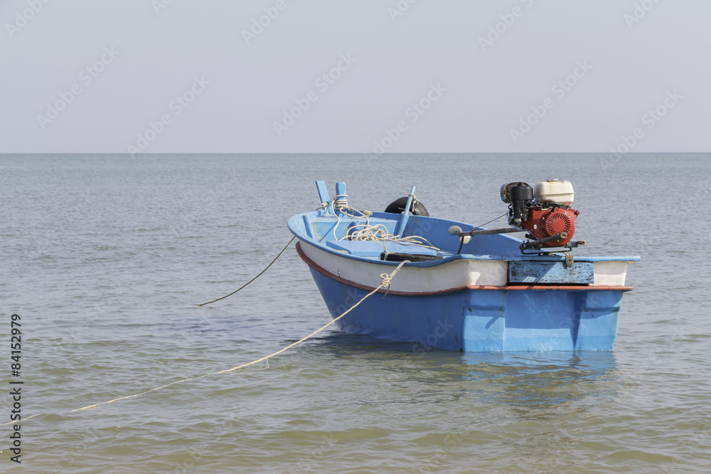 Small blue boat on the sea