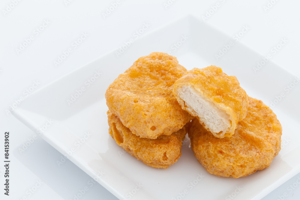 Group of fried chicken nuggets on white dish Group of fried chicken nuggets on white dish