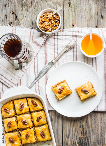 pieces of baklava with honey and nuts, top view, rustic